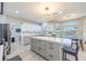 This spacious kitchen features an island with lots of storage, bar seating, and white cabinets and countertops at 747 Canyon Crest Dr, Las Vegas, NV 89123
