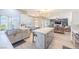 Spacious kitchen with island and breakfast bar seamlessly flows into the adjacent living area creating an open and inviting space at 747 Canyon Crest Dr, Las Vegas, NV 89123