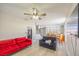 Open-concept living room with comfortable seating, a ceiling fan, wood-look flooring, and natural light at 747 Canyon Crest Dr, Las Vegas, NV 89123