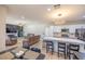 Open-concept kitchen and living area with stone fireplace, recessed lighting, and ceiling fan offers a comfortable space at 747 Canyon Crest Dr, Las Vegas, NV 89123