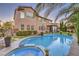 A gorgeous backyard pool with a spa, lush lawn, and relaxing pergola, perfect for outdoor living at 7908 Horse Bridle St, Las Vegas, NV 89131