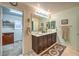 Charming bathroom featuring double vanity, tiled floors, walk-in closet and lots of lights at 7908 Horse Bridle St, Las Vegas, NV 89131