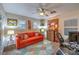 Bright bedroom featuring a ceiling fan, desk, lamps and a comfortable orange couch at 7908 Horse Bridle St, Las Vegas, NV 89131