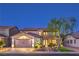 Charming two-story home exterior at twilight showcasing manicured lawn and a brick driveway at 7908 Horse Bridle St, Las Vegas, NV 89131