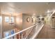 The upstairs hallway showcases a chandelier, carpet, and neutral paint at 7908 Horse Bridle St, Las Vegas, NV 89131