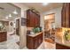 An open kitchen features granite countertops, wood cabinets, and backyard access at 7908 Horse Bridle St, Las Vegas, NV 89131