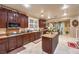 A functional kitchen features tile floors, wood cabinets, granite countertops and stainless appliances at 7908 Horse Bridle St, Las Vegas, NV 89131