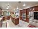 The spacious kitchen features wood cabinets, stainless steel appliances, and granite countertops at 7908 Horse Bridle St, Las Vegas, NV 89131