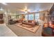 Spacious living room featuring a comfortable sectional sofa, large windows, and an open layout at 7908 Horse Bridle St, Las Vegas, NV 89131