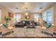 A well-lit living room features stylish furnishings, hardwood floors, and a decorative chandelier at 7908 Horse Bridle St, Las Vegas, NV 89131
