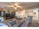 Entertain in this living room featuring neutral walls, ceiling fan and wrought iron staircase at 7908 Horse Bridle St, Las Vegas, NV 89131