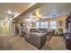 Spacious living room area featuring a cozy sectional sofa, carpet, and natural light at 7908 Horse Bridle St, Las Vegas, NV 89131