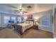 Bright main bedroom featuring an office space, ceiling fan and bright blue walls at 7908 Horse Bridle St, Las Vegas, NV 89131