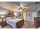 Bright main bedroom featuring a ceiling fan, bedside lamps and bright blue walls at 7908 Horse Bridle St, Las Vegas, NV 89131
