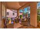 Cozy covered patio with comfortable seating, a water fountain, and views of the well-kept yard at 7908 Horse Bridle St, Las Vegas, NV 89131