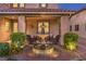 Covered outdoor patio with water feature, comfortable seating, and lush garden landscaping at 7908 Horse Bridle St, Las Vegas, NV 89131
