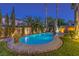 Stunning pool and spa area surrounded by lush greenery and accented with decorative rock border at 7908 Horse Bridle St, Las Vegas, NV 89131