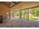 Spacious covered patio with grill, brick flooring, and view of the beautifully landscaped backyard at 8340 Jeremiahs Lodge Ave, Las Vegas, NV 89131
