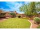 Well-maintained backyard with lush lawn, mature trees, and partial shade offers outdoor enjoyment at 8340 Jeremiahs Lodge Ave, Las Vegas, NV 89131