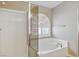 Well-lit bathroom featuring a separate tub and shower with neutral wall color at 8340 Jeremiahs Lodge Ave, Las Vegas, NV 89131