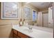 Bright bathroom with a white countertop and sink, decorative lighthouse, and framed wall art at 8340 Jeremiahs Lodge Ave, Las Vegas, NV 89131