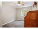 Cozy bedroom with soft carpet, ceiling fan, and a window, offering a simple and inviting space at 8340 Jeremiahs Lodge Ave, Las Vegas, NV 89131