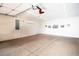 Spacious three car garage featuring sealed floors, ample lighting, and air conditioning at 8340 Jeremiahs Lodge Ave, Las Vegas, NV 89131