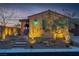 Well-lit front exterior of this desert home with desert landscaping, a charming entrance, and an attached garage at 9091 Becket Ranch Ct, Las Vegas, NV 89113