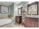 Well lit bathroom features dual sinks, stone floors, and a separate soaking tub and shower at 9900 Summer Ash Ct # 101, Las Vegas, NV 89134