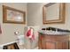 Elegant powder room with dark wood vanity and sophisticated decor at 9900 Summer Ash Ct # 101, Las Vegas, NV 89134