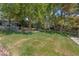 Expansive lawn area is surrounded by mature trees for privacy and shade at 9900 Summer Ash Ct # 101, Las Vegas, NV 89134