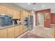 Modern kitchen features stainless appliances, granite counters, and tile floors at 9900 Summer Ash Ct # 101, Las Vegas, NV 89134