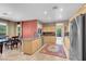 Spacious kitchen with stainless appliances, breakfast bar, and tile flooring at 9900 Summer Ash Ct # 101, Las Vegas, NV 89134