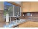 The Kitchen sink features granite counters and a window with a view at 9900 Summer Ash Ct # 101, Las Vegas, NV 89134