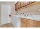 Laundry room with laundry machines, a wash sink, and overhead cabinets at 9900 Summer Ash Ct # 101, Las Vegas, NV 89134