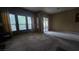 Spacious living room with large windows and a sliding glass door, offering plenty of natural light and access to the outdoors at 9900 Summer Ash Ct # 101, Las Vegas, NV 89134