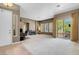 A large living room with a fireplace, neutral walls, and a sliding glass door leading to the backyard at 9900 Summer Ash Ct # 101, Las Vegas, NV 89134