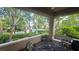 Relaxing covered patio with comfortable seating, offering a serene outdoor space with views of the pool and lush landscaping at 9900 Summer Ash Ct # 101, Las Vegas, NV 89134