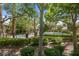 Community pool surrounded by lush landscaping and mature trees and greenery at 9900 Summer Ash Ct # 101, Las Vegas, NV 89134