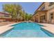 A backyard with pool has a waterfall feature and a covered patio area at 9992 Peak Lookout St, Las Vegas, NV 89178