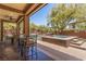 The covered patio overlooks a uniquely designed pool and spa combination, surrounded by lush landscaping at 9992 Peak Lookout St, Las Vegas, NV 89178