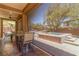 The covered patio offers an obstructed view of the uniquely designed pool and spa combination at 9992 Peak Lookout St, Las Vegas, NV 89178