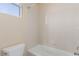 Clean, minimalist bathroom featuring a shower and tub combination with white tile and simple fixtures at 9992 Peak Lookout St, Las Vegas, NV 89178