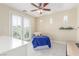 Bright bedroom featuring french doors, neutral walls, and modern ceiling fan and a stuffed animal on the bed at 9992 Peak Lookout St, Las Vegas, NV 89178