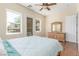 Comfortable bedroom with wood floors, natural light, and stylish dresser at 9992 Peak Lookout St, Las Vegas, NV 89178