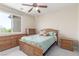 Bedroom with a full-size bed and stylish furniture with a beautiful view of the outside at 9992 Peak Lookout St, Las Vegas, NV 89178