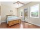 Bright bedroom with hardwood floors, ceiling fan, and direct access to outdoor space at 9992 Peak Lookout St, Las Vegas, NV 89178