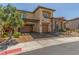 Two-story home with a three-car garage and xeriscaped front yard at 9992 Peak Lookout St, Las Vegas, NV 89178