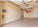 Spacious garage with epoxy flooring, overhead storage, and ample room for vehicles and projects at 9992 Peak Lookout St, Las Vegas, NV 89178