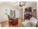 Stylish home office with tray ceilings, hardwood floors, and a cozy seating area at 9992 Peak Lookout St, Las Vegas, NV 89178